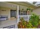 Cozy front porch with plants and bench at 8805 Van Fleet Rd, Riverview, FL 33578