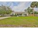 Charming home with a well-maintained lawn, black shutters, and inviting front porch at 8805 Van Fleet Rd, Riverview, FL 33578