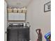 Functional laundry room with a washer and dryer, complemented by overhead storage cabinets and a print at 8805 Van Fleet Rd, Riverview, FL 33578