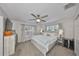 This cozy main bedroom features a ceiling fan, neutral walls and an abundance of natural light at 8805 Van Fleet Rd, Riverview, FL 33578
