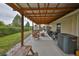 Covered patio features wood furniture and an outdoor grilling area at 8805 Van Fleet Rd, Riverview, FL 33578