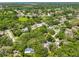Picturesque aerial shot of a neighborhood, showcasing lush greenery and serene residential homes at 940 Woodland Dr, Palm Harbor, FL 34683