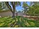 Expansive backyard featuring a screened-in pool and lush green grass, perfect for outdoor relaxation at 940 Woodland Dr, Palm Harbor, FL 34683