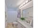 Bathroom featuring vanity with marble countertop, neutral tiles, and shower with curtain at 940 Woodland Dr, Palm Harbor, FL 34683