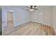 Bright bedroom features wood-look flooring and double doors to the closet at 940 Woodland Dr, Palm Harbor, FL 34683