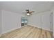 Bright bedroom features wood-look flooring and sliding doors leading to the pool area at 940 Woodland Dr, Palm Harbor, FL 34683