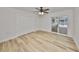 Bright bedroom features wood-look flooring and sliding doors leading to the backyard at 940 Woodland Dr, Palm Harbor, FL 34683