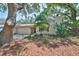 Charming single-story home with mature landscaping and inviting curb appeal at 940 Woodland Dr, Palm Harbor, FL 34683