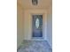 Inviting front entrance with a decorative door and stylish stone flooring at 940 Woodland Dr, Palm Harbor, FL 34683