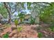 Charming single-Gathering home with a well-manicured front yard, mature trees and attractive landscaping at 940 Woodland Dr, Palm Harbor, FL 34683