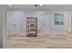 Neutral hallway with wood-look flooring, recessed lighting and closet space at 940 Woodland Dr, Palm Harbor, FL 34683