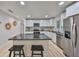 Well-lit kitchen with sleek appliances and granite island with seating at 940 Woodland Dr, Palm Harbor, FL 34683