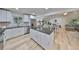 Modern kitchen with white cabinets, granite countertops, and stainless steel appliances at 940 Woodland Dr, Palm Harbor, FL 34683