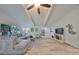 Bright living room with high ceilings, ceiling fan, and new floors at 940 Woodland Dr, Palm Harbor, FL 34683