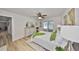 Airy main bedroom features sliding glass doors, ceiling fan, and light-colored wood flooring at 940 Woodland Dr, Palm Harbor, FL 34683