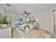 Light-filled bedroom with ceiling fan and sliding doors to the pool area at 940 Woodland Dr, Palm Harbor, FL 34683