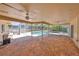 Spacious screened patio with brick floor leading to the inviting pool at 940 Woodland Dr, Palm Harbor, FL 34683
