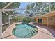 Private screened-in pool area, perfect for relaxing and entertaining guests at 940 Woodland Dr, Palm Harbor, FL 34683
