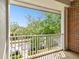 A nice balcony view of the greenery and street below with bright sunny sky in the background at 10011 Parley Dr, Tampa, FL 33626