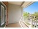 Brick balcony offering a serene view of lush trees and the neighborhood, perfect for relaxation and fresh air at 10011 Parley Dr, Tampa, FL 33626
