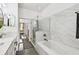 Bathroom featuring a jacuzzi tub, a glass shower, and sleek transitional design at 10011 Parley Dr, Tampa, FL 33626