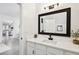 Bright bathroom with a vanity featuring white marble countertops and a modern black faucet at 10011 Parley Dr, Tampa, FL 33626