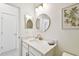 Stylish bathroom featuring a round mirror, quartz countertop, modern lighting and hardware, exuding minimalist elegance at 10011 Parley Dr, Tampa, FL 33626