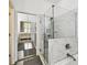 Stylish bathroom featuring a marble shower and tub, with glass enclosure, and modern fixtures for a spa-like experience at 10011 Parley Dr, Tampa, FL 33626