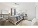 Comfortable bedroom with light wooden furniture, plush textiles, and lots of natural light from the large window at 10011 Parley Dr, Tampa, FL 33626