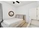 Bedroom with neutral decor, a round mirror and white walls at 10011 Parley Dr, Tampa, FL 33626