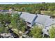 An exterior aerial view displays townhomes with porches and mature tree landscaping at 10011 Parley Dr, Tampa, FL 33626