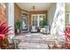 Inviting front porch with brick flooring, comfortable seating, and stylish decor for outdoor enjoyment at 10011 Parley Dr, Tampa, FL 33626