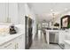 Modern kitchen featuring stainless steel appliances, white cabinets, quartz countertops, and open concept design at 10011 Parley Dr, Tampa, FL 33626