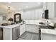 Modern kitchen boasts white cabinets, stainless steel appliances and marble countertops at 10011 Parley Dr, Tampa, FL 33626
