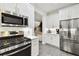 This gourmet kitchen features stainless steel appliances, white cabinets, and ample counter space at 10011 Parley Dr, Tampa, FL 33626