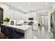 Bright kitchen with stainless steel appliances, white cabinets, quartz countertops, and bar seating area at 10011 Parley Dr, Tampa, FL 33626