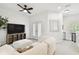 Bright living area with a comfortable sofa, TV, french doors to a balcony, and ample natural light at 10011 Parley Dr, Tampa, FL 33626