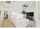Cozy living room featuring a comfortable white sofa, entertainment center with TV, and a ceiling fan for relaxation at 10011 Parley Dr, Tampa, FL 33626