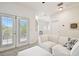 A bright, inviting living room offers a comfortable white sofa and access to a balcony through glass doors at 10011 Parley Dr, Tampa, FL 33626