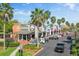 A vibrant shopping center with palm trees, clearly marked parking spaces, and a variety of storefronts at 10011 Parley Dr, Tampa, FL 33626