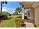 Charming front porch with a lush, green lawn and pond view at 1004 Norfork Island Ct # 28, Sun City Center, FL 33573