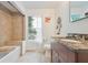 Bright bathroom featuring granite counters, tile flooring, and tub with a window view at 105 W Columbus Dr, Tampa, FL 33602