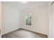 An empty bedroom with plank flooring, a window view, and neutral paint at 105 W Columbus Dr, Tampa, FL 33602