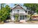 Charming two-story home with a double porch and a welcoming light blue front door at 105 W Columbus Dr, Tampa, FL 33602