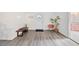 Well-lit foyer with modern flooring, minimal furniture, and a decorative plant creating an inviting entrance at 105 W Columbus Dr, Tampa, FL 33602