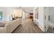 Open concept living room with modern decor, wood flooring and a view of the adjacent dining room at 105 W Columbus Dr, Tampa, FL 33602