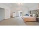 Spacious main bedroom featuring an ensuite bathroom, a high headboard, and carpet floors at 105 W Columbus Dr, Tampa, FL 33602