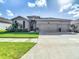 Attractive single-story home features lush landscaping and a convenient three-car garage at 10978 Laxer Cay Loop, San Antonio, FL 33576