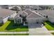 Charming single-story home featuring a three-car garage and meticulously manicured landscaping at 10978 Laxer Cay Loop, San Antonio, FL 33576
