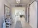 Warm foyer with tile flooring, decorative bench, and views into the living spaces at 10978 Laxer Cay Loop, San Antonio, FL 33576